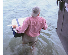 John MacDonald carrying food to shore