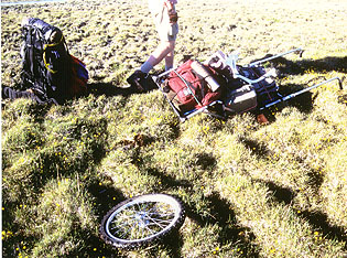With 30 miles under its belt, our little rickshaw breaks an axle.